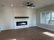 Bright living room with a modern fireplace, hardwood floors, and a large window at 1915 Cassia Aly, Kennesaw, GA 30144