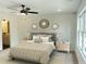 Cozy main bedroom with neutral tones, ceiling fan, and access to a bathroom at 1915 Cassia Aly, Kennesaw, GA 30144