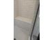 Shower stall with white subway tile walls, tiled shower seat, and mosaic tile floor at 1915 Cassia Aly, Kennesaw, GA 30144