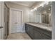 Well-lit bathroom features a double vanity with granite counters and tiled walk-in shower at 201 Daisy Ct, Cartersville, GA 30121