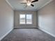 Bedroom featuring plush carpeting, neutral paint, a ceiling fan, and bright double windows at 201 Daisy Coourt, Cartersville, GA 30121