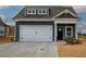 Charming two-story home with blue siding, white garage door, and stone accents at 201 Daisy Ct, Cartersville, GA 30121