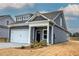 Exterior angle of a home, showing the garage, entryway, stone detail, and light landscaping at 201 Daisy Ct, Cartersville, GA 30121