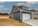 A house with a garage and dormer windows against a cloudy sky and dry lawn at 201 Daisy Coourt, Cartersville, GA 30121