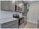 Modern kitchen with gray cabinets, stainless steel appliances, and granite countertops at 201 Daisy Ct, Cartersville, GA 30121