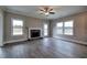 Spacious living room with a fireplace, ceiling fan, and lots of natural light at 201 Daisy Coourt, Cartersville, GA 30121