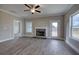 Living room featuring a fireplace, ceiling fan, and access to backyard at 201 Daisy Coourt, Cartersville, GA 30121