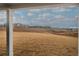 A view from a porch looks out to a hill and a building in the background on a partially cloudy day at 201 Daisy Coourt, Cartersville, GA 30121