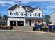 New home construction with visible Tyvek wrap and a blue dumpster at 2160 Suncrest Point, Marietta, GA 30064