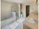 Bright bathroom featuring a double sink vanity, soaking tub and glass enclosed shower, and tiled floors at 4405 Thorngate Ln, Acworth, GA 30101