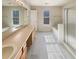 Bright bathroom featuring a large mirror, double vanity, and a bathtub at 4405 Thorngate Ln, Acworth, GA 30101