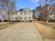 Charming townhome with beige siding and blue shutters, complemented by a spacious driveway and manicured landscaping at 4405 Thorngate Ln, Acworth, GA 30101