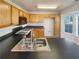 Functional kitchen with black countertops, wooden cabinets, and modern appliances. Ready for cooking at 4405 Thorngate Ln, Acworth, GA 30101