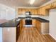 Functional kitchen with wooden cabinets, black countertops, and a range oven at 4405 Thorngate Ln, Acworth, GA 30101