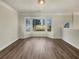 Empty living area with hardwood floors and bright bay windows at 4405 Thorngate Ln, Acworth, GA 30101