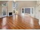 Bright living room with hardwood floors, fireplace, and large windows offering plenty of natural light at 4405 Thorngate Ln, Acworth, GA 30101