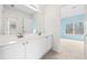 Bright bathroom featuring dual sinks with white cabinets at 1168 Christiana Xing, Lawrenceville, GA 30043