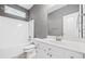 Modern bathroom features a white vanity, large mirror, and shower-tub combo at 1168 Christiana Xing, Lawrenceville, GA 30043