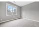 Bright bedroom features neutral carpet, a large window, and light gray walls at 1168 Christiana Xing, Lawrenceville, GA 30043