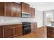 Kitchen featuring stainless steel appliances, dark cabinets, and sleek countertops at 1168 Christiana Xing, Lawrenceville, GA 30043