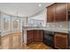 Kitchen area featuring a breakfast bar, stainless steel dishwasher, and dark cabinets at 1168 Christiana Xing, Lawrenceville, GA 30043