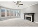 Inviting living room with a fireplace, carpeted floors, and large windows offering natural light at 1168 Christiana Xing, Lawrenceville, GA 30043