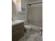 This bathroom features marbled floors, modern vanity, and a shower over the tub at 1711 Nappa Valley Se Ct, Smyrna, GA 30080