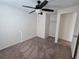 Bedroom includes neutral walls, carpet, a ceiling fan, and a closet for storage at 1711 Nappa Valley Se Ct, Smyrna, GA 30080