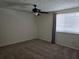 Comfortable carpeted bedroom featuring a ceiling fan, a window with blinds, and neutral paint at 1711 Nappa Valley Se Ct, Smyrna, GA 30080