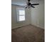 This bedroom features carpet, a ceiling fan, and a window that lets in natural light at 1711 Nappa Valley Se Ct, Smyrna, GA 30080