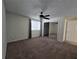 Cozy bedroom featuring a ceiling fan, closet with mirror doors, and a window with coverings at 1711 Nappa Valley Se Ct, Smyrna, GA 30080