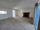 Bright living room featuring a traditional fireplace, carpet, and large sliding glass doors at 1711 Nappa Valley Se Ct, Smyrna, GA 30080