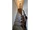 Carpeted staircase with dark wooden railing leading to the upper level of the home at 1711 Nappa Valley Se Ct, Smyrna, GA 30080