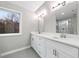 This primary bathroom features a double vanity, lots of natural light and tile floors at 3185 Tackett Rd, Douglasville, GA 30135