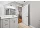 Bathroom with sleek vanity, a large mirror, and modern lighting, adjacent to the doorway at 3185 Tackett Rd, Douglasville, GA 30135