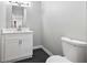 Bathroom with vanity, toilet, and sleek black tile flooring at 3185 Tackett Rd, Douglasville, GA 30135