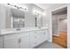 This primary bathroom features a double vanity, tile floors and a glass shower at 3185 Tackett Rd, Douglasville, GA 30135