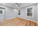 Bright bedroom features hardwood floors, a ceiling fan, and natural light from the windows at 3185 Tackett Rd, Douglasville, GA 30135