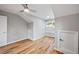 Bedroom with hardwood floors, ceiling fan, and windows, creating a comfortable and inviting space at 3185 Tackett Rd, Douglasville, GA 30135