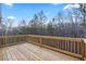 A wooden deck provides serene views of surrounding trees and sky at 3185 Tackett Rd, Douglasville, GA 30135