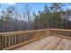 A wooden deck provides serene views of surrounding trees at 3185 Tackett Rd, Douglasville, GA 30135