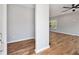 Bright entryway with hardwood floors leading to a living room with a ceiling fan and lots of natural light at 3185 Tackett Rd, Douglasville, GA 30135