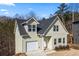 Charming two-story home with a light green exterior and a neatly attached single-car garage, aerial view at 3185 Tackett Rd, Douglasville, GA 30135