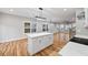 Spacious kitchen with white cabinets, hardwood floors, a center island and modern lighting at 3185 Tackett Rd, Douglasville, GA 30135