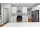 Modern kitchen featuring stainless steel appliances, white cabinets, and an island with a white countertop at 3185 Tackett Rd, Douglasville, GA 30135