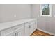 Kitchen nook featuring bright white cabinets with white countertops and hardwood floors at 3185 Tackett Rd, Douglasville, GA 30135