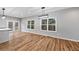 Open living room featuring wood floors, gray walls, modern lighting, and natural light leading to an outdoor deck at 3185 Tackett Rd, Douglasville, GA 30135