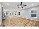 Spacious living room with hardwood floors, modern ceiling fan, and staircase to the second floor at 3185 Tackett Rd, Douglasville, GA 30135