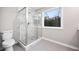 This primary bathroom features a glass-enclosed tile shower and a privacy window at 3185 Tackett Rd, Douglasville, GA 30135