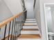 Elegant staircase with wood treads and black iron railing, leading to the upper level at 3185 Tackett Rd, Douglasville, GA 30135